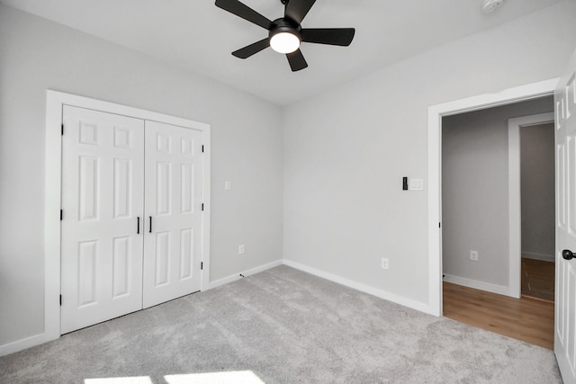 unfurnished bedroom with a closet, baseboards, and carpet