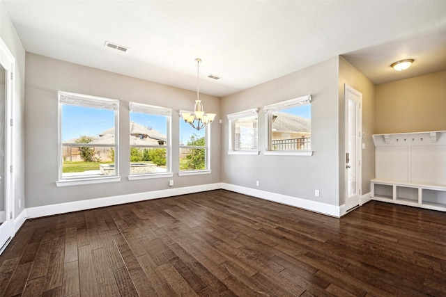 unfurnished dining area featuring baseboards, dark wood-type flooring, and a healthy amount of sunlight