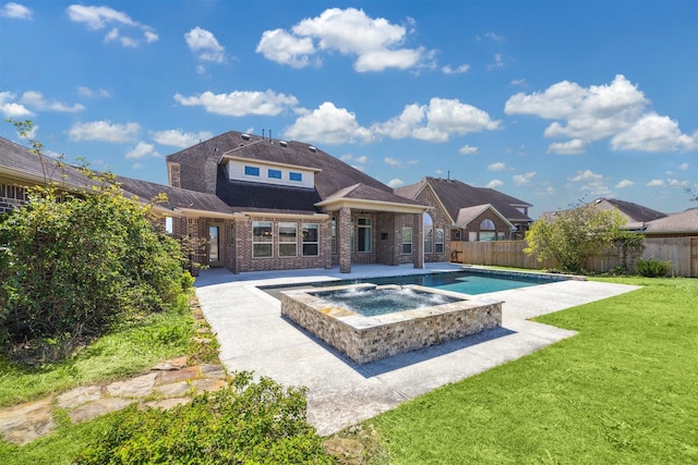 back of house with a patio, brick siding, an in ground hot tub, and a fenced backyard