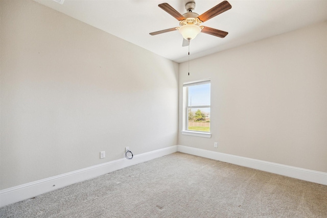 empty room featuring light carpet, a ceiling fan, and baseboards