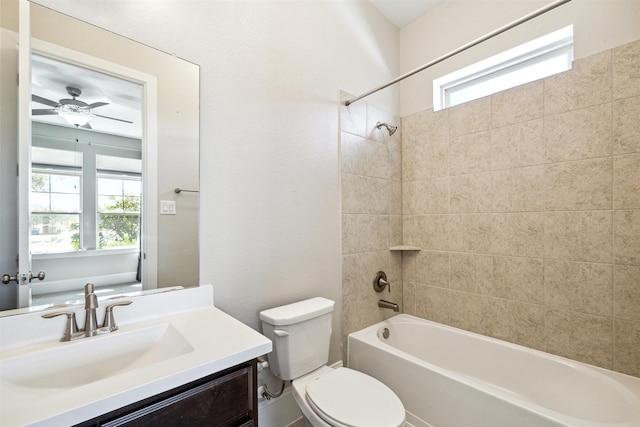 full bathroom featuring a healthy amount of sunlight, vanity, toilet, and shower / bathing tub combination