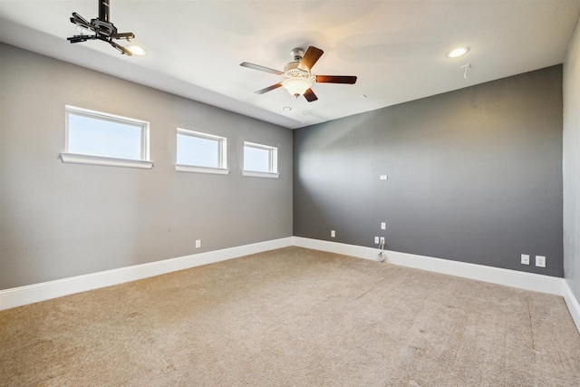 carpeted spare room featuring recessed lighting, baseboards, and ceiling fan