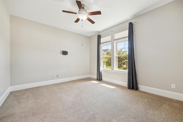 unfurnished room featuring baseboards, ceiling fan, and carpet flooring