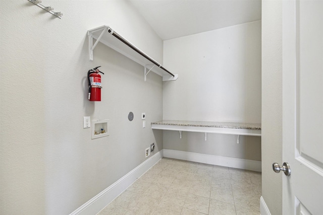 clothes washing area with laundry area, hookup for a washing machine, electric dryer hookup, and baseboards