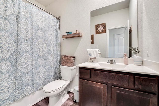 full bath with vanity, shower / bath combination with curtain, toilet, and wood finished floors