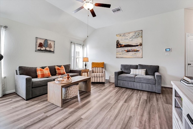 living room with lofted ceiling, a ceiling fan, light wood-style floors, and baseboards