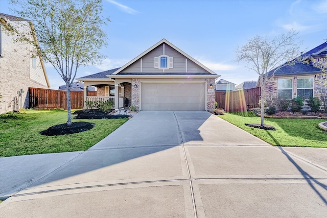 view of front of home featuring concrete driveway, fence, and a front yard