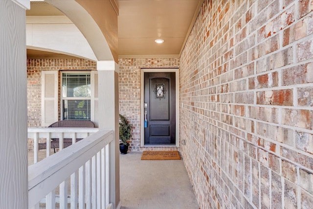 doorway to property with brick siding