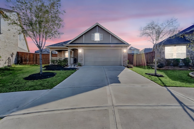 view of front facade featuring brick siding, driveway, a front lawn, and fence