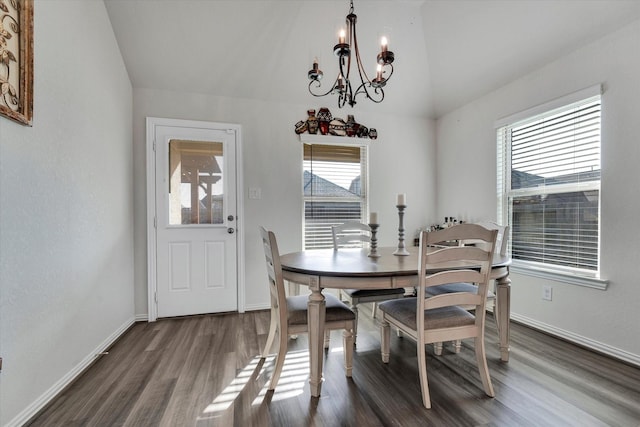 dining area with dark wood-style floors, baseboards, a chandelier, and vaulted ceiling