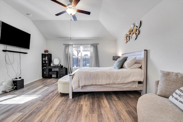 bedroom featuring lofted ceiling, wood finished floors, and ceiling fan