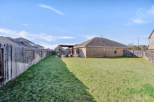 view of yard featuring a gazebo and a fenced backyard