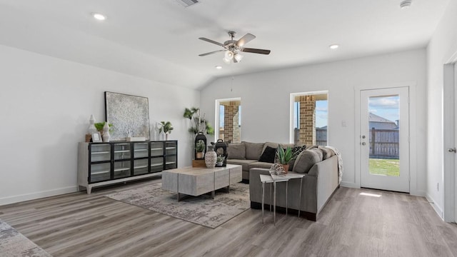 living room with recessed lighting, baseboards, light wood-style flooring, and vaulted ceiling