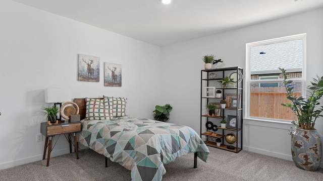 bedroom featuring baseboards and carpet floors