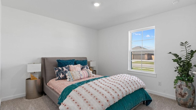 bedroom with baseboards and carpet floors