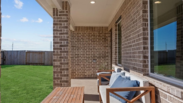 view of patio with an outdoor living space and fence