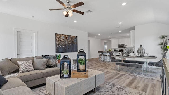 living room featuring recessed lighting, visible vents, light wood-style floors, and a ceiling fan