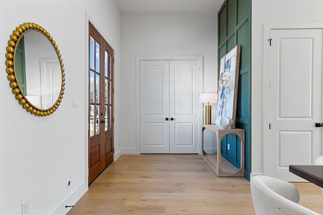 entryway with light wood-style flooring and baseboards