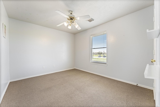 unfurnished room with visible vents, carpet flooring, baseboards, and ceiling fan