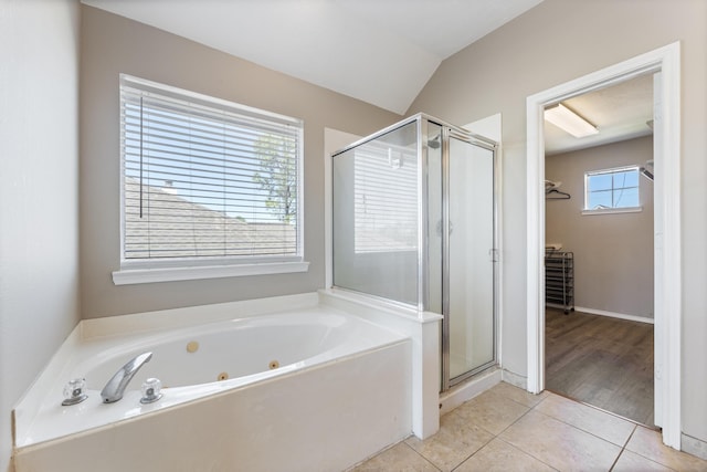 full bathroom with tile patterned flooring, a shower stall, a spacious closet, and a tub with jets