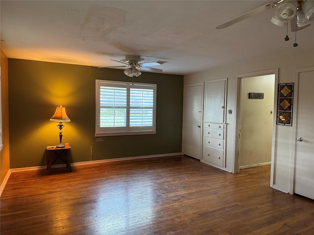 unfurnished room featuring ceiling fan, baseboards, and wood finished floors