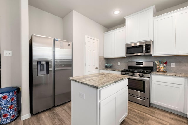 kitchen featuring decorative backsplash, light wood-style floors, and appliances with stainless steel finishes