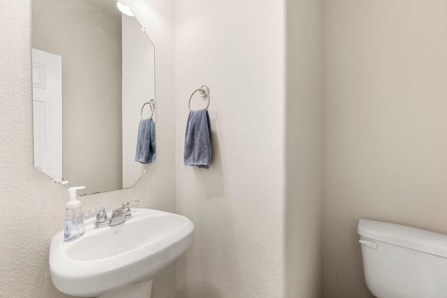 bathroom with toilet and a sink