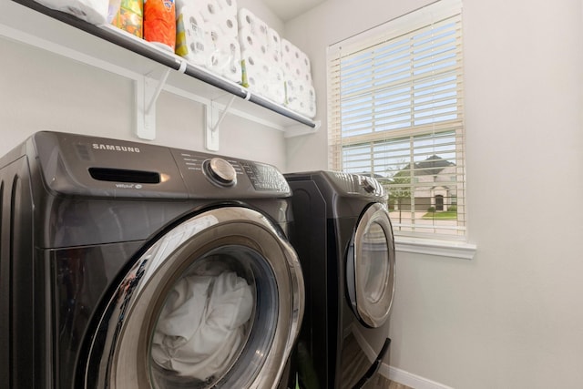 laundry room with baseboards, washing machine and dryer, and laundry area