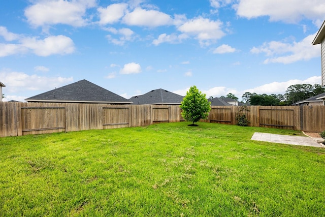 view of yard with a fenced backyard