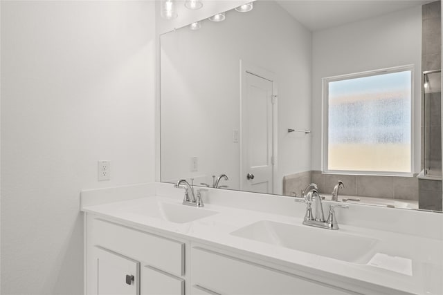 bathroom featuring a sink and double vanity