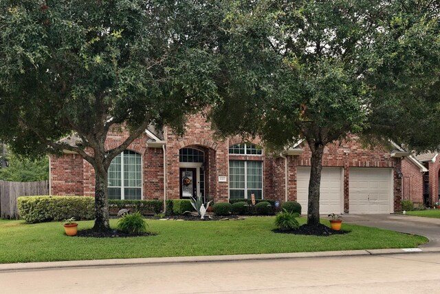 16815 Coronado Springs Dr, Spring, TX 77379 - view of front of house with a front yard, brick siding, and concrete driveway