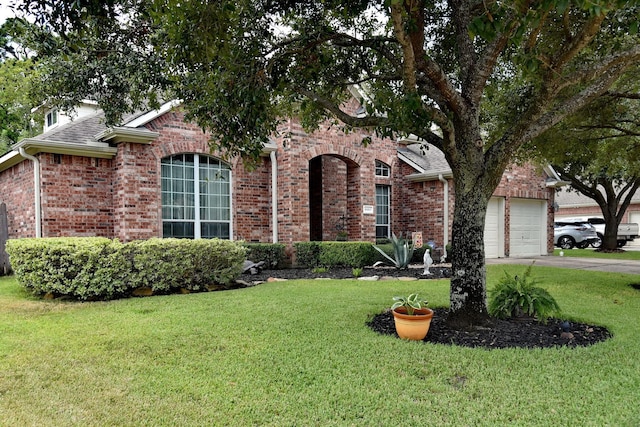 16815 Coronado Springs Dr, Spring, TX 77379 - view of front of property with driveway, roof with shingles, brick siding, a front lawn, and a garage