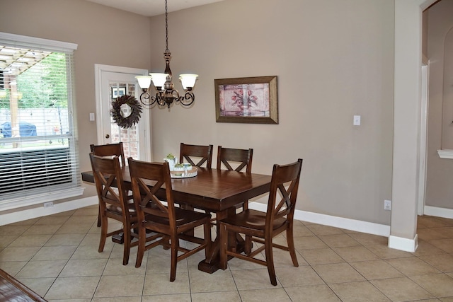16815 Coronado Springs Dr, Spring, TX 77379 - dining space with light tile patterned flooring, baseboards, arched walkways, and a chandelier