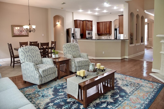 16815 Coronado Springs Dr, Spring, TX 77379 - living area with arched walkways, a notable chandelier, and wood finished floors
