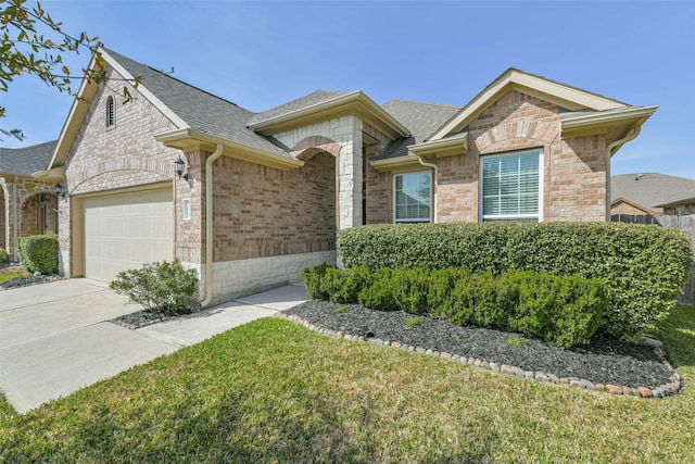 ranch-style house with brick siding, roof with shingles, concrete driveway, and an attached garage