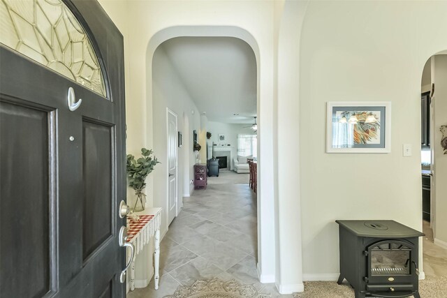 hallway with arched walkways and baseboards