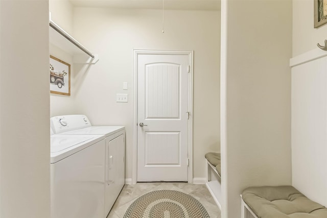 clothes washing area with washer and clothes dryer, laundry area, and light tile patterned floors