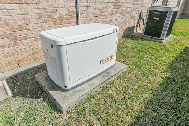 details with brick siding, a power unit, and central AC