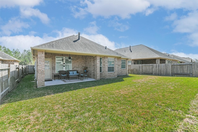 rear view of house with a patio, a fenced backyard, brick siding, and a lawn