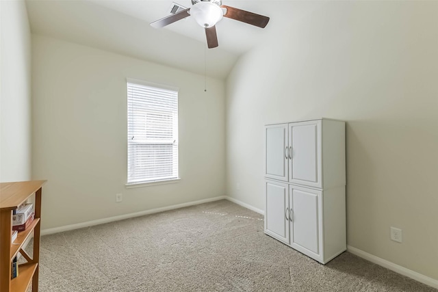 interior space with light carpet, visible vents, lofted ceiling, and baseboards