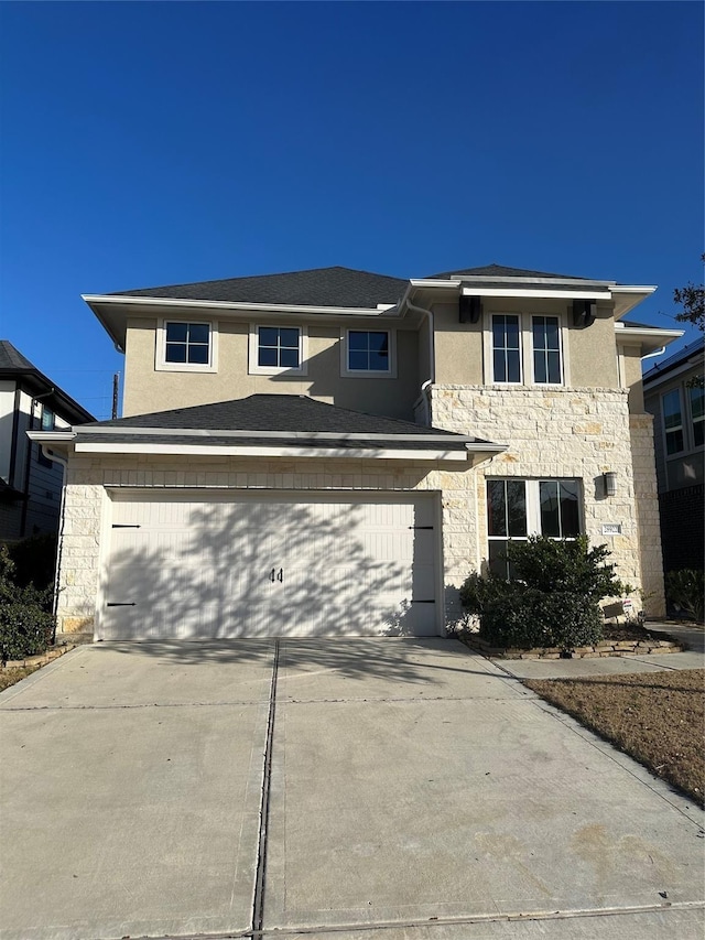 view of front facade featuring stone siding, stucco siding, concrete driveway, and a garage