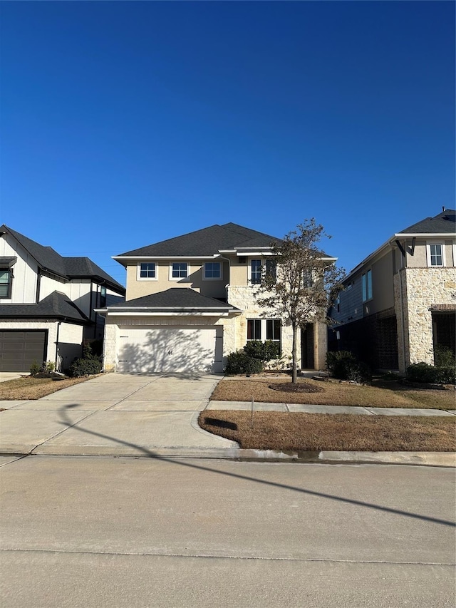 view of front of home featuring an attached garage and concrete driveway