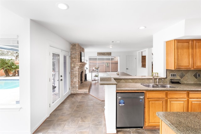 kitchen with a sink, backsplash, dishwasher, and recessed lighting