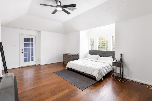 bedroom with baseboards, hardwood / wood-style floors, a ceiling fan, and vaulted ceiling