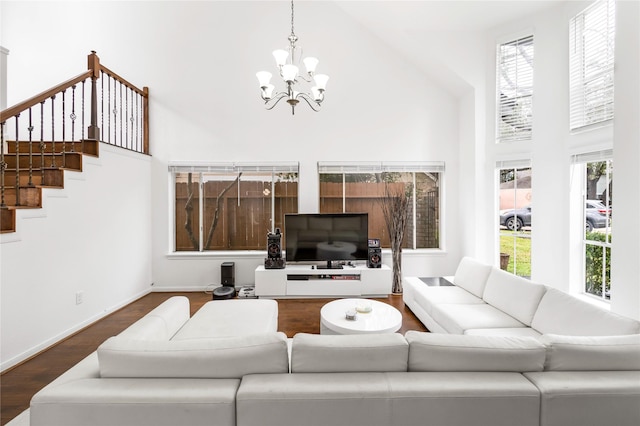 living room with a high ceiling, plenty of natural light, baseboards, and dark wood-style flooring