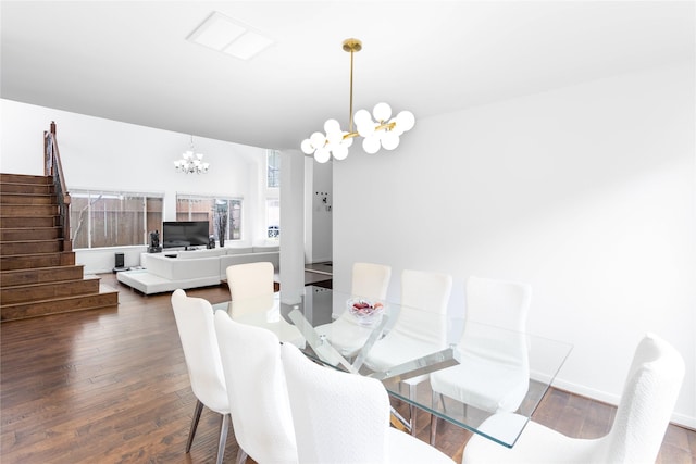 dining room with stairs, an inviting chandelier, baseboards, and hardwood / wood-style floors