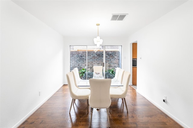 dining area with baseboards, visible vents, and wood-type flooring