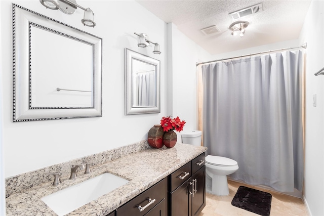 bathroom featuring visible vents, a textured ceiling, vanity, and toilet