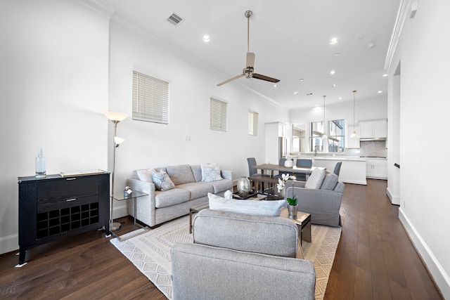 2721 Maxroy St, Houston, TX 77007 - living area with visible vents, dark wood finished floors, crown molding, baseboards, and ceiling fan
