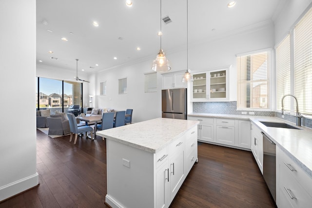 2721 Maxroy St, Houston, TX 77007 - kitchen with visible vents, stainless steel appliances, crown molding, and a sink